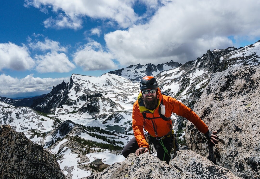 person climbing mountain