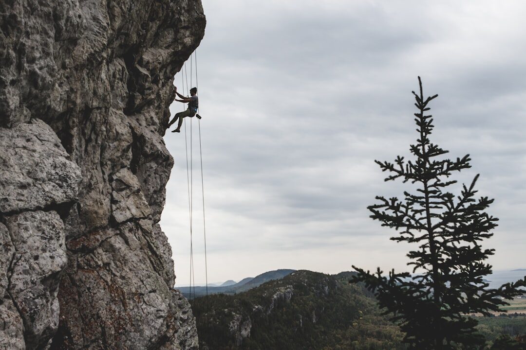 person climbing mountain