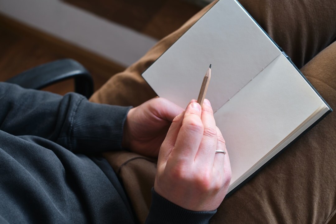 person writing goals in notebook