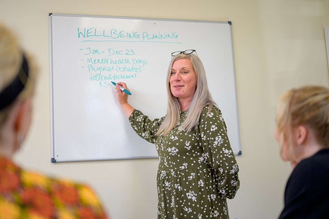 person explaining ideas on whiteboard